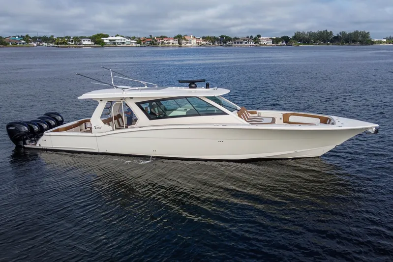  Yacht Photos Pics 2020 Scout 530 LXF luxury boat on calm water, showcasing sleek design and powerful engines.