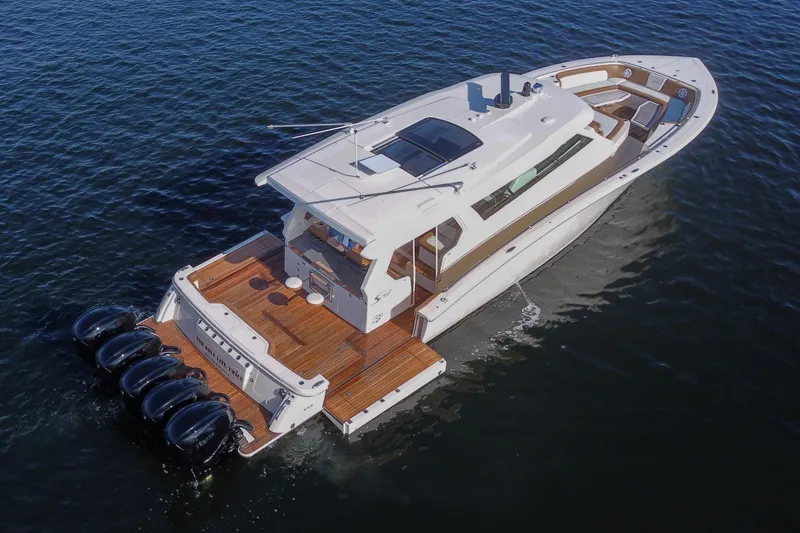  Yacht Photos Pics 2020 Scout 530 LXF luxury boat cruising on open water, aerial view.