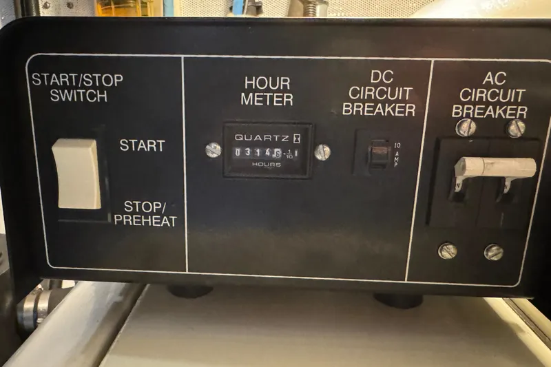 Encore II Yacht Photos Pics Control panel of a 1986 Canoe Cove Sports Sedan with hour meter and circuit breakers.