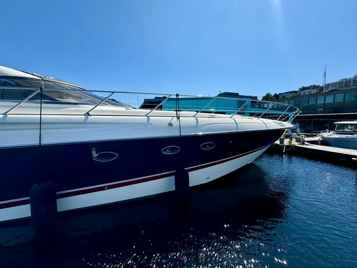  Yacht Photos Pics 1998 Sunseeker Predator 63 yacht docked in marina under clear blue sky.