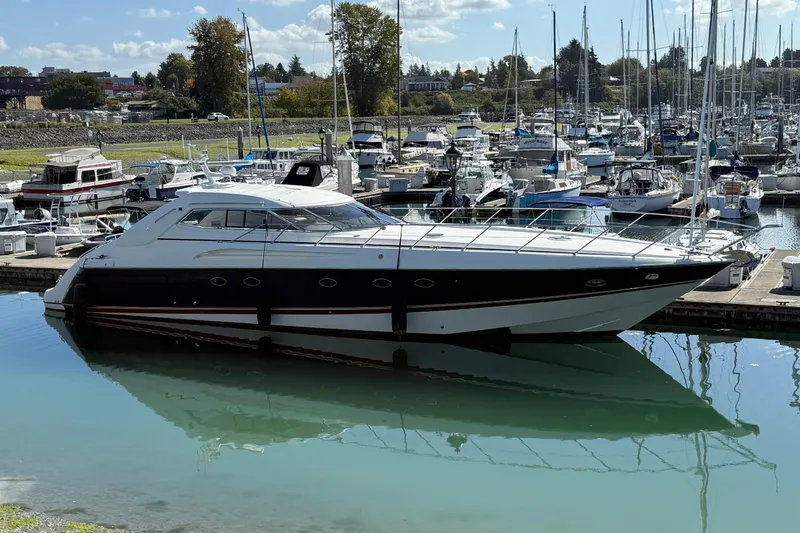  Yacht Photos Pics 1998 Sunseeker Predator 63 yacht docked in a marina, surrounded by other boats.