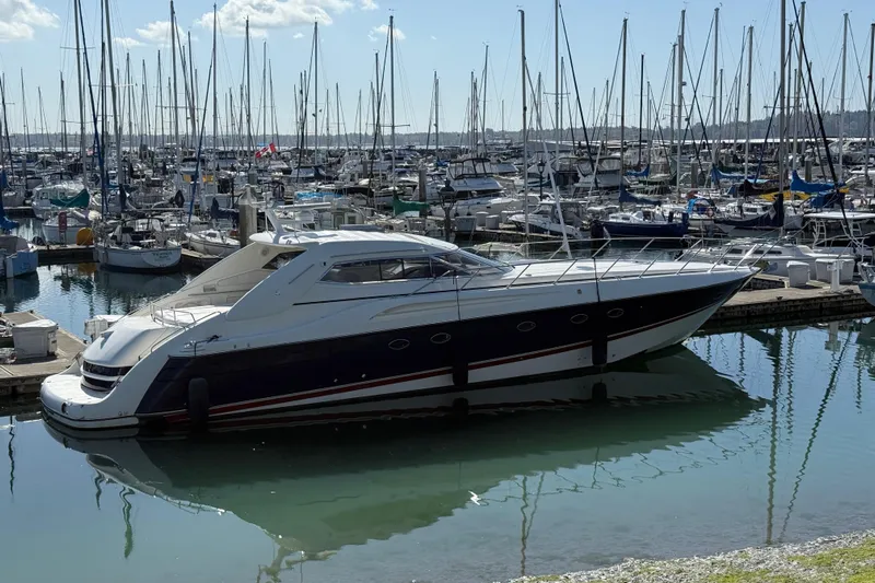  Yacht Photos Pics Sunseeker Predator 63 yacht, 1998 model, docked in a marina with numerous sailboats.