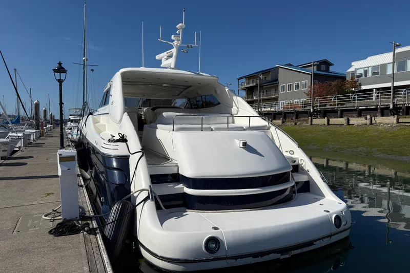  Yacht Photos Pics 1998 Sunseeker Predator 63 yacht docked at marina, clear blue sky background.