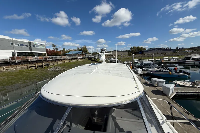  Yacht Photos Pics 1998 Sunseeker Predator 63 yacht docked at marina under blue sky.