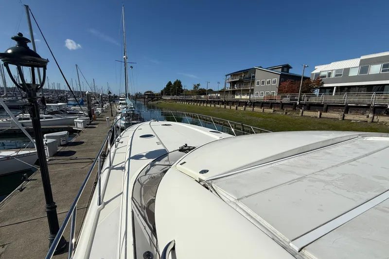  Yacht Photos Pics 1998 Sunseeker Predator 63 yacht docked at marina under clear blue sky.