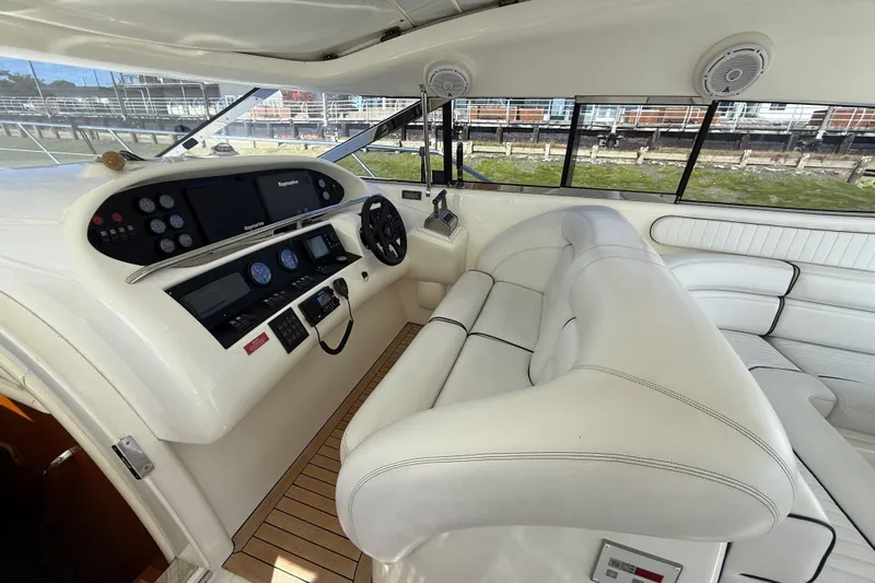  Yacht Photos Pics Luxurious 1998 Sunseeker Predator 63 yacht cockpit with white leather seating and modern controls.