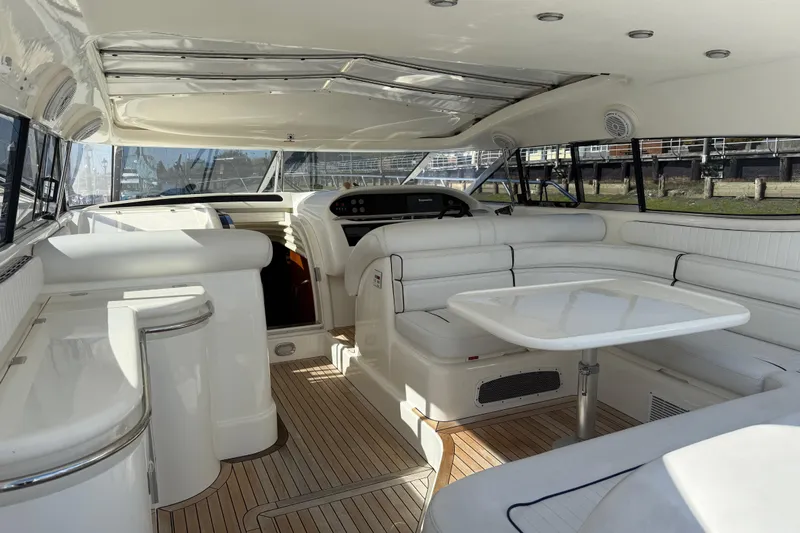  Yacht Photos Pics Luxurious interior of a 1998 Sunseeker Predator 63 yacht with white seating and table.