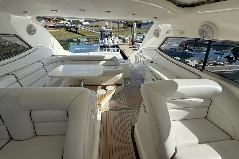  Yacht Photos Pics Luxurious interior of a 1998 Sunseeker Predator 63 yacht with white seating and wooden flooring.