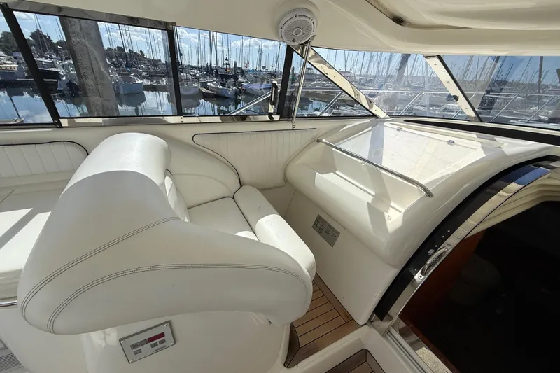  Yacht Photos Pics Interior of 1998 Sunseeker Predator 63 yacht with white seating and marina view.