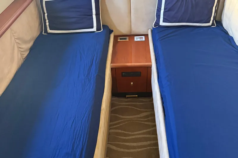  Yacht Photos Pics Twin beds with blue sheets in a 1998 Sunseeker Predator 63 yacht cabin.