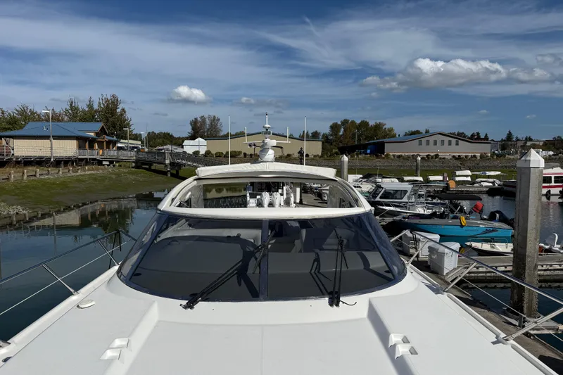  Yacht Photos Pics 1998 Sunseeker Predator 63 yacht docked at a marina under a clear blue sky.