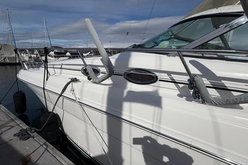 Devocean Yacht Photos Pics 2003 Sea Ray 360 Sundancer yacht docked at marina under cloudy sky.