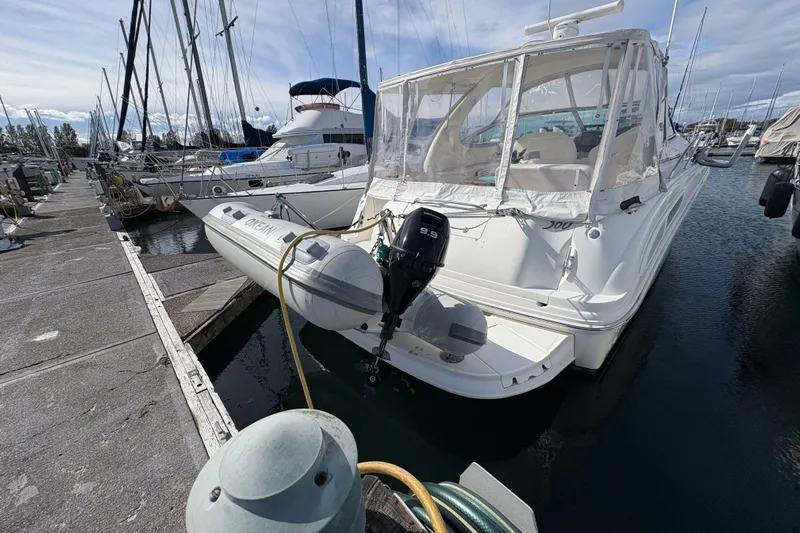 Devocean Yacht Photos Pics 2003 Sea Ray 360 Sundancer yacht docked at marina with inflatable boat attached.