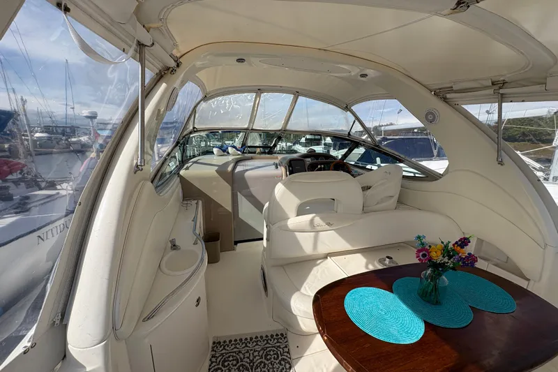 Devocean Yacht Photos Pics Interior of 2003 Sea Ray 360 Sundancer yacht with elegant seating and table setting.