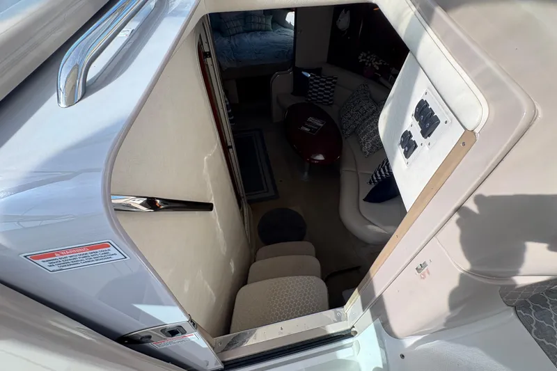 Devocean Yacht Photos Pics Interior view of 2003 Sea Ray 360 Sundancer yacht cabin with seating and table.