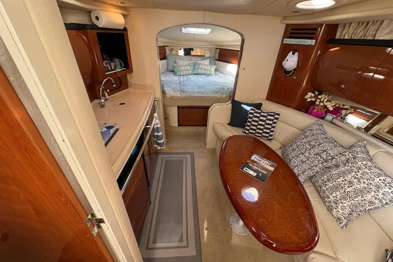Devocean Yacht Photos Pics 2003 Sea Ray 360 Sundancer interior with kitchenette, seating area, and cozy bedroom.