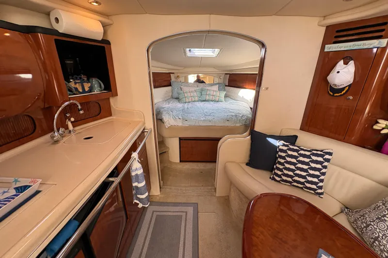 Devocean Yacht Photos Pics Interior of 2003 Sea Ray 360 Sundancer yacht with cozy cabin and kitchenette.