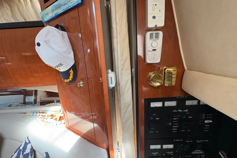 Devocean Yacht Photos Pics Interior of 2003 Sea Ray 360 Sundancer with control panel and wooden cabinetry.