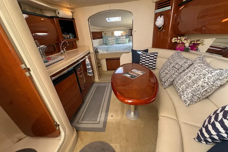 Devocean Yacht Photos Pics Interior of 2003 Sea Ray 360 Sundancer yacht with cozy seating and kitchenette.