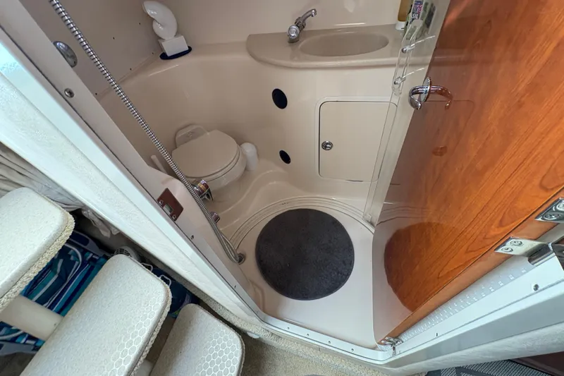 Devocean Yacht Photos Pics 2003 Sea Ray 360 Sundancer bathroom with toilet, sink, and shower area.