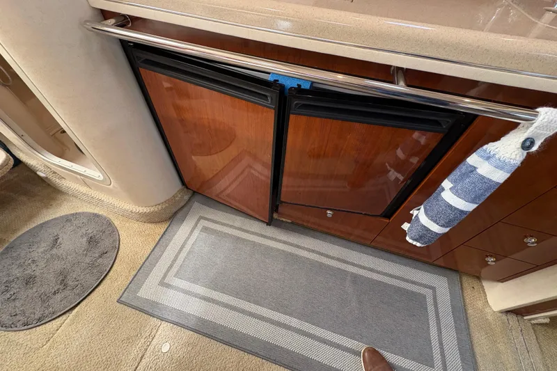 Devocean Yacht Photos Pics 2003 Sea Ray 360 Sundancer interior with wood cabinetry and carpeted flooring.