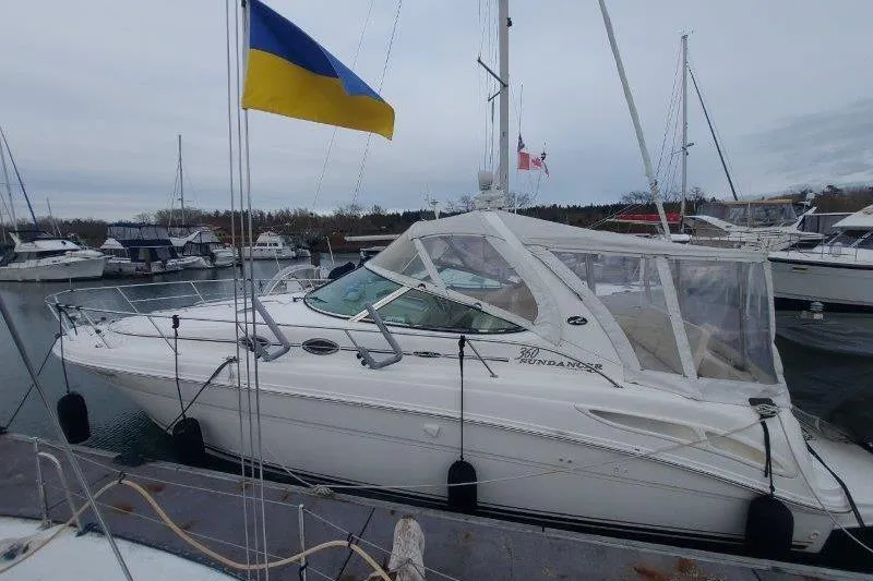 Devocean Yacht Photos Pics 2003 Sea Ray 360 Sundancer yacht docked, featuring a Ukrainian flag.