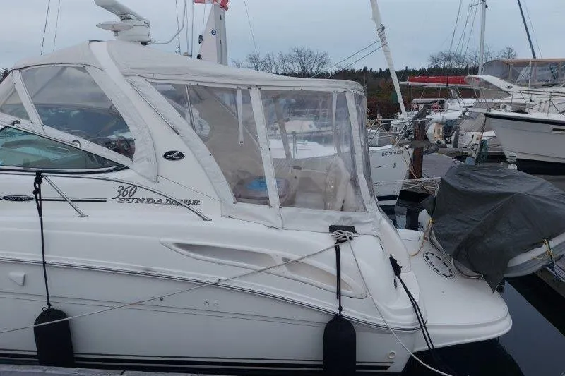 Devocean Yacht Photos Pics 2003 Sea Ray 360 Sundancer yacht docked at marina, side view.