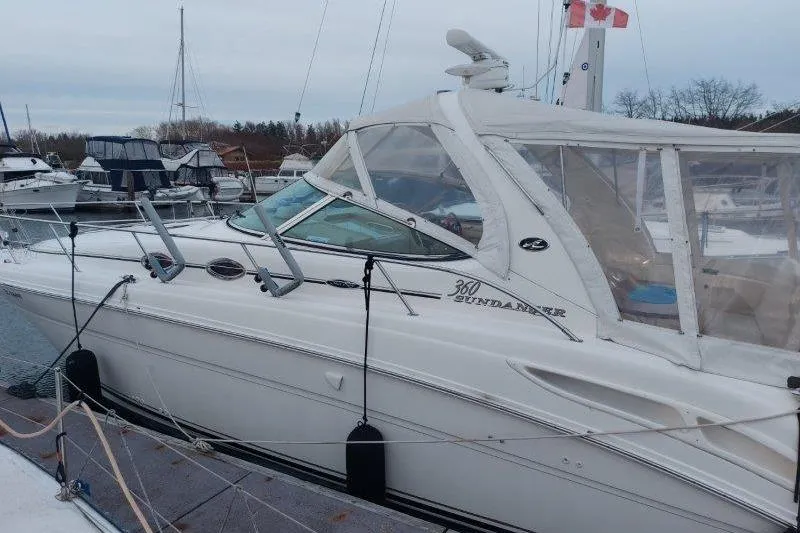 Devocean Yacht Photos Pics 2003 Sea Ray 360 Sundancer docked at marina, side view with clear canopy.