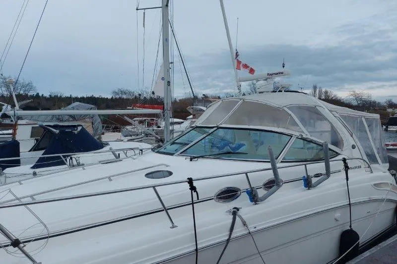 Devocean Yacht Photos Pics 2003 Sea Ray 360 Sundancer yacht docked at marina under cloudy sky.