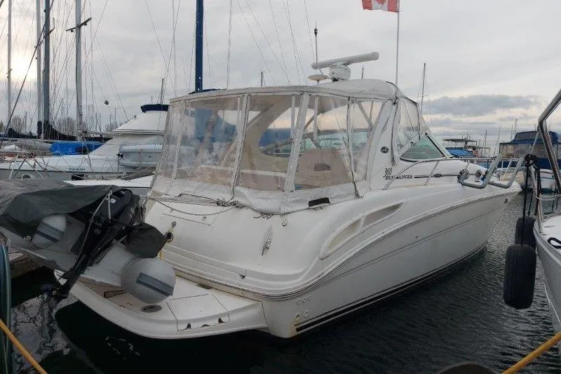 Devocean Yacht Photos Pics 2003 Sea Ray 360 Sundancer yacht docked in a marina, rear view.