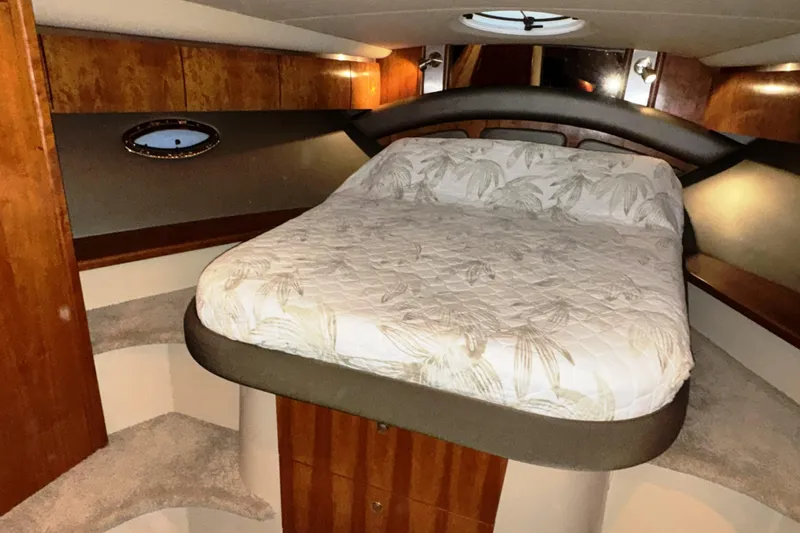  Yacht Photos Pics Luxurious cabin interior of 2005 Cruisers Yachts 420 Express with cozy bed and wood accents.