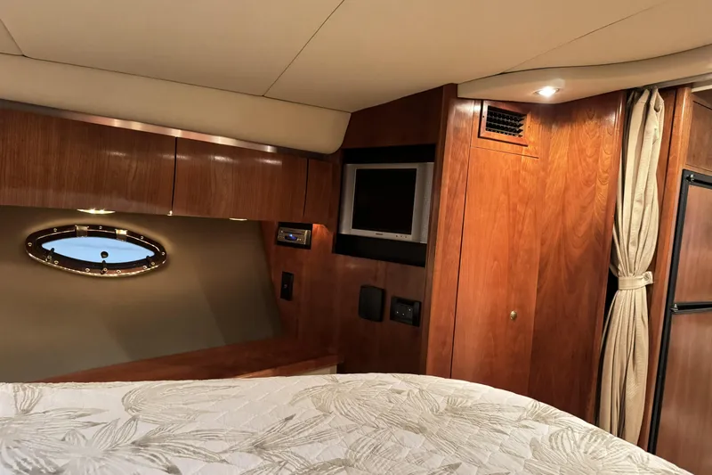  Yacht Photos Pics Interior of 2005 Cruisers Yachts 420 Express with wood paneling and porthole window.