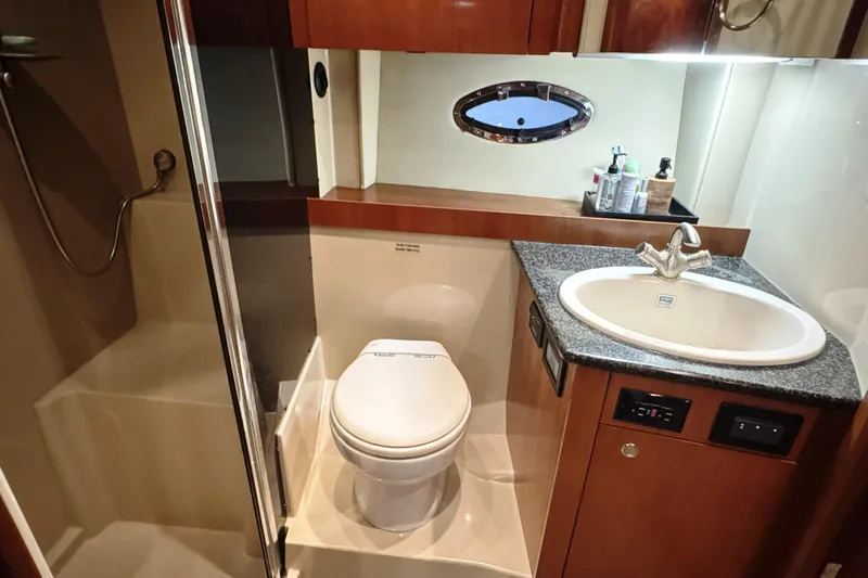  Yacht Photos Pics Luxurious bathroom in 2005 Cruisers Yachts 420 Express with shower, toilet, and sink.
