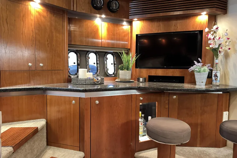  Yacht Photos Pics Luxurious 2005 Cruisers Yachts 420 Express interior with elegant wood cabinetry and modern amenities.