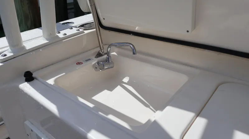 Big Sea Yacht Photos Pics 2020 Cobia 350 Center Console boat sink with chrome faucet in sunlight.