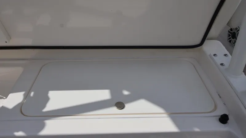 Big Sea Yacht Photos Pics 2020 Cobia 350 Center Console storage compartment, white interior, shadowed lighting.