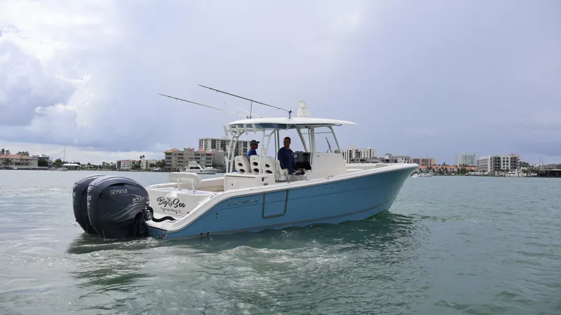 Big Sea Yacht Photos Pics 2020 Cobia 350 Center Console boat on water, cityscape in background.