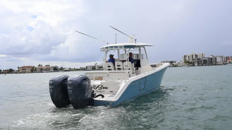 Big Sea Yacht Photos Pics 2020 Cobia 350 Center Console boat cruising on water with twin Yamaha engines.