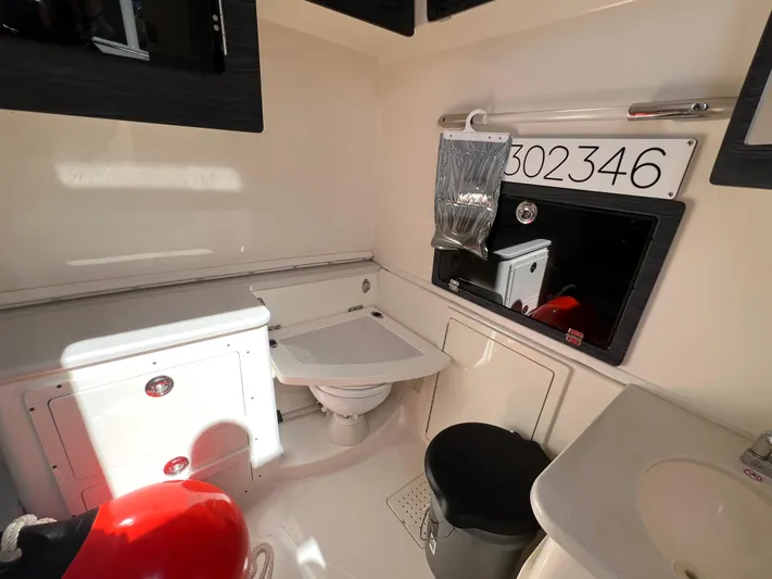 Big Sea Yacht Photos Pics 2020 Cobia 350 Center Console interior with storage, sink, and seating area.