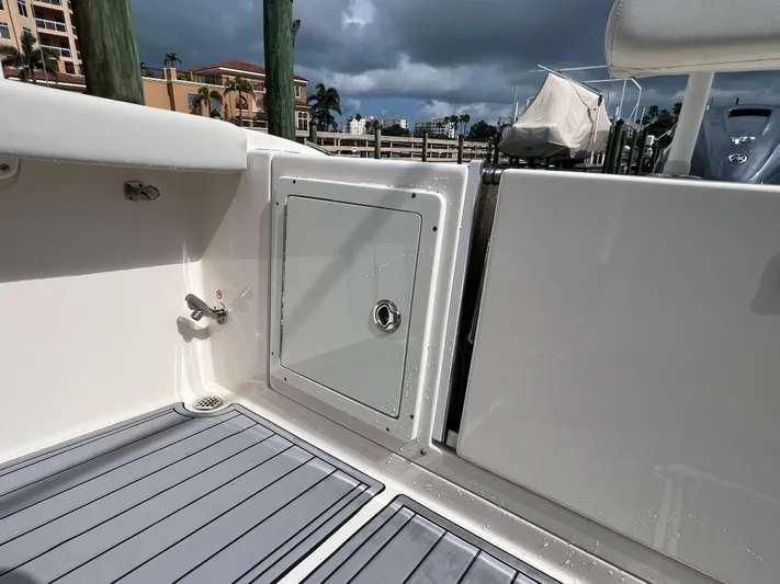 Big Sea Yacht Photos Pics 2020 Cobia 350 Center Console boat deck with storage compartment and faucet.
