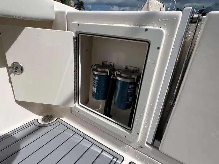 Big Sea Yacht Photos Pics 2020 Cobia 350 Center Console boat with open compartment showing dual filters.