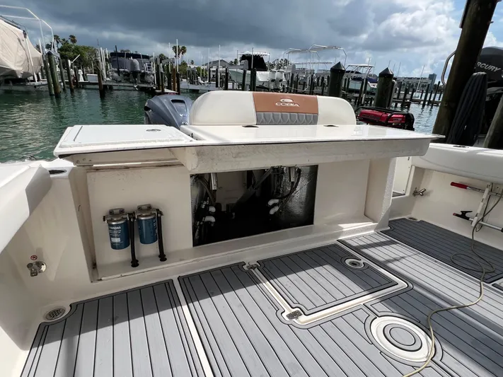 Big Sea Yacht Photos Pics 2020 Cobia 350 Center Console boat interior at marina, featuring deck and storage area.