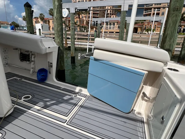 Big Sea Yacht Photos Pics 2020 Cobia 350 Center Console boat interior with blue storage compartment and dock view.