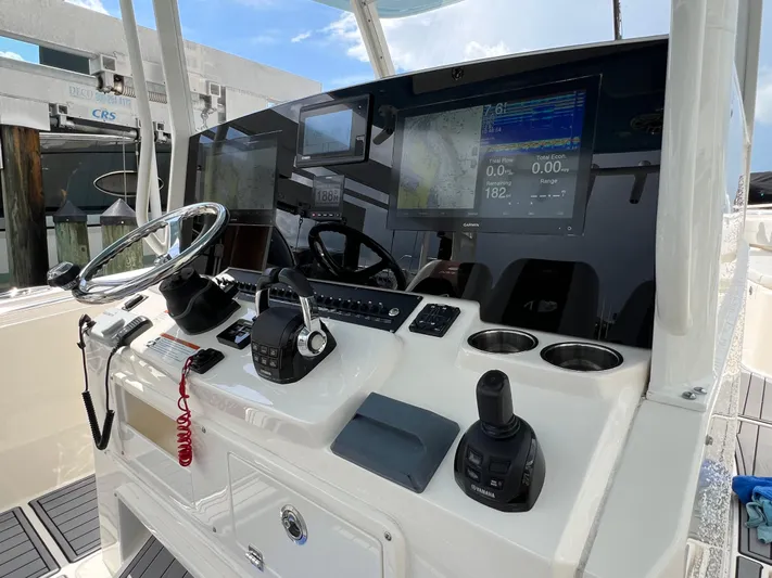 Big Sea Yacht Photos Pics 2020 Cobia 350 Center Console boat dashboard with steering wheel and navigation screens.
