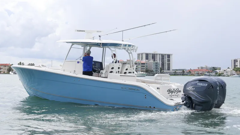 Big Sea Yacht Photos Pics 2020 Cobia 350 Center Console boat cruising with Yamaha engines in a coastal cityscape.