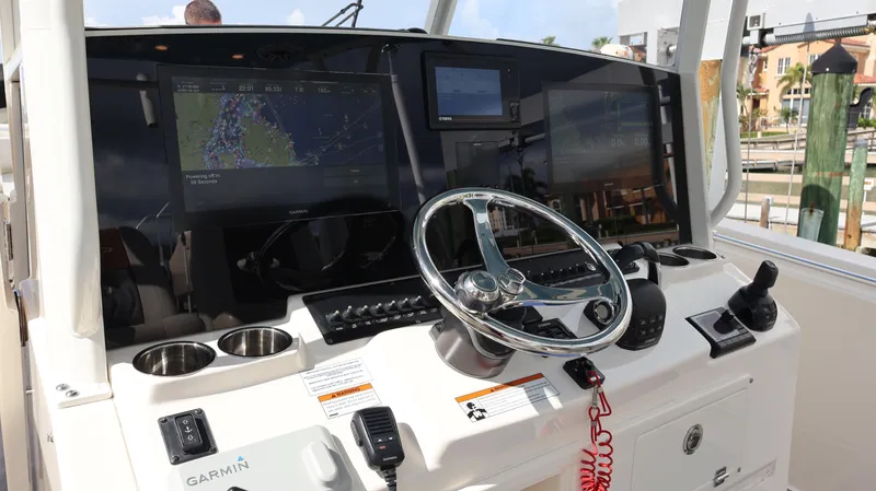 Big Sea Yacht Photos Pics 2020 Cobia 350 Center Console helm with Garmin navigation system and steering wheel.