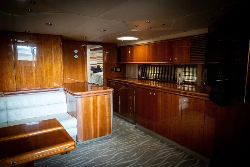  Yacht Photos Pics Interior of 1998 Sunseeker Predator 63 yacht with wooden cabinetry and white seating.