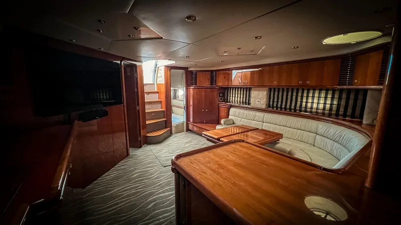 Yacht Photos Pics Interior of 1998 Sunseeker Predator 63 yacht with wooden furnishings and cozy seating area.