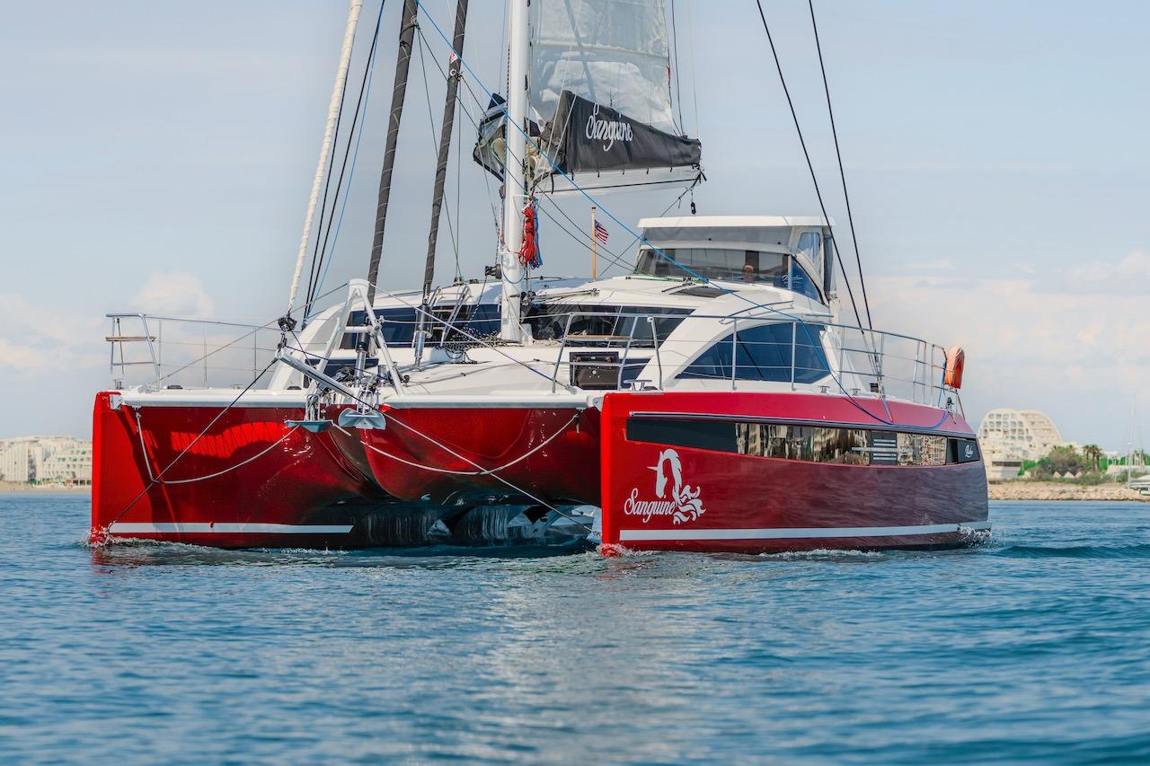 Red Privilege Signature 510 catamaran on water, year 2025.
