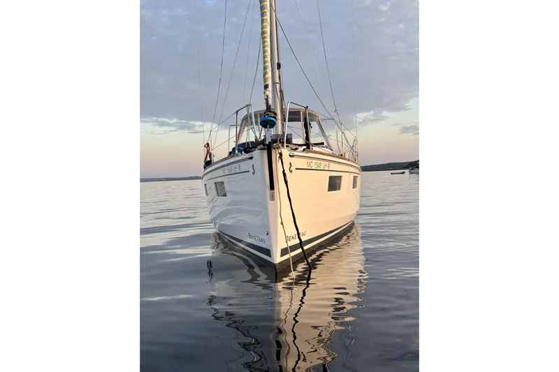  Yacht Photos Pics 2019 Beneteau Oceanis 35.1 sailboat on calm water at sunset.